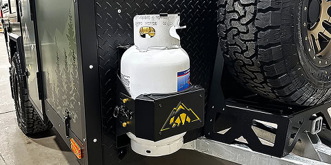 Propane tank mounted on Arkto Campers off-road trailer beside spare tire