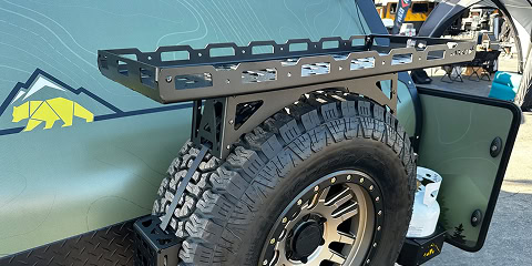 Rear cargo rack mounted above spare tire on Arkto Campers overland trailer