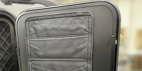 Entry door window cover for Arkto Campers overland travel trailer